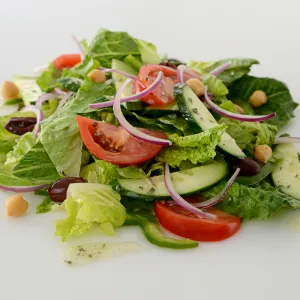 Mound of Greek salad on white surface