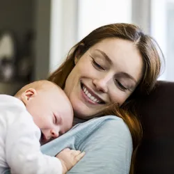 A mother sleeping with her baby