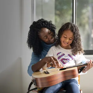 Mother and Daughter Playing Guitar