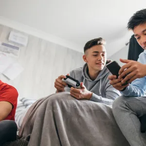 A group of teenage boys playing videogames.
