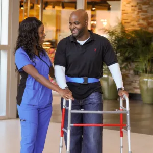 Nurse helping patient during therapy session.