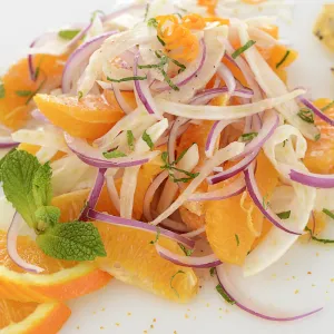 Mound of orange fennel salad with orange garnishes
