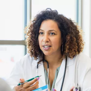 A physician talks to her patient.