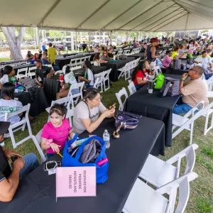 People under a banquet tent at the 2025 transplant reunion picnic