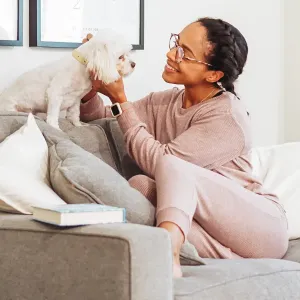 A woman playing with her dog.