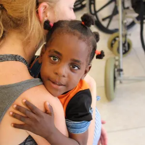 Woman holding a small child.