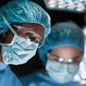 two surgeons performing an operation.