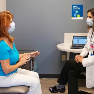 A patient discussing something to her doctor