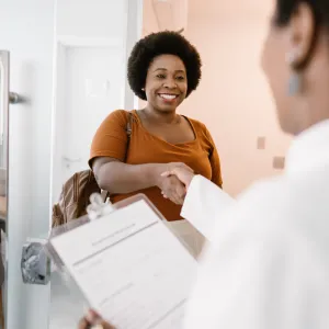 Woman shaking her doctor's hand.