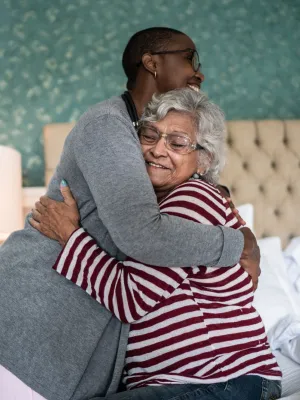 A Nurse Embraces Her Elderly Patient