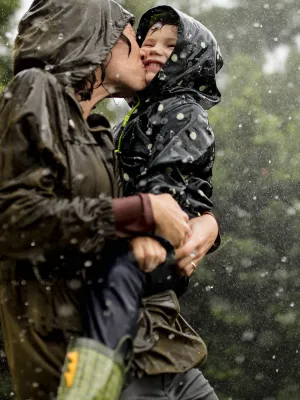Mom and little boy playing in the rain.