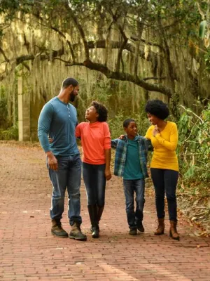 A family walks through the trees