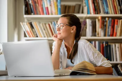 A Teen Stares Out the Window While in the Middle of Her Homework