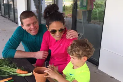 A family sitting outside at a table.
