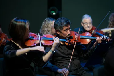 Grace Lai and Dr. Vincent Hsu with the AdventHealth employee orchestra.