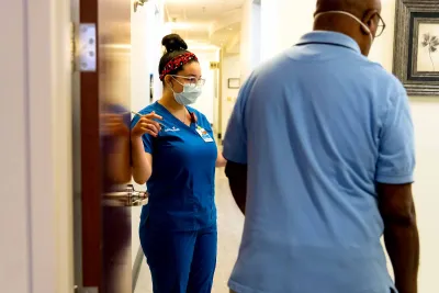 A man at a doctor's office practicing safety measures. 