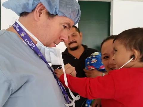 A doctor holds a child