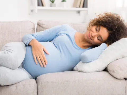 A pregnant woman resting at home.