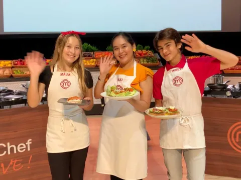 Three contestants with their dishes from the Master Chef competition