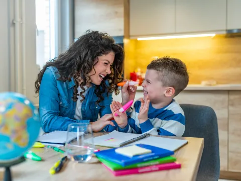 Mother and Son HAve Fun Coloring and Learning at the Kitchen Table