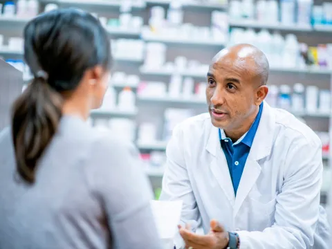 A Pharmacist Speaks to a Patient About Medication