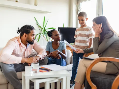 Two Parents and a Child Speak to a Mental Health Professional