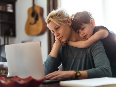 A Son Hugs His Mother While She Tries to Find Help on the Internet