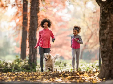 A Mother and Daughter Go For a Jog in a Wooded Park
