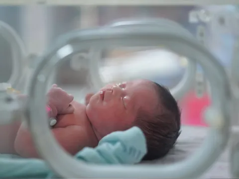 A New Born Baby Sleeps in an Incubator