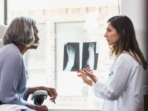 A Provider Goes Over a Foot X-Ray with Her Patient