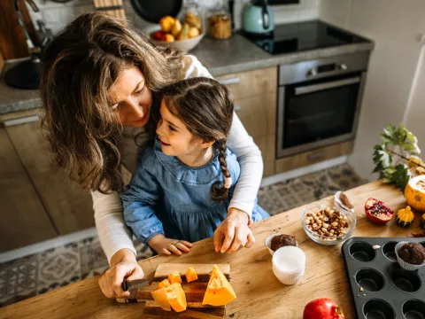 A Mother and Her Young Daughter Bake in Their Kitchen