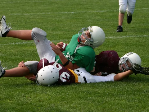 Teens playing football