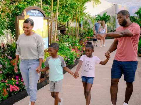 A Family Walks the Butterfly Garden at Epcot