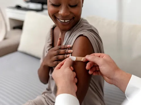 A Woman Smiles After Receiving Her Flu Shot