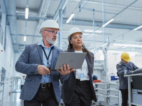 Two Supervisors Inspect a Factory Floor