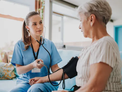A Nurse Takes a Patient's Blood Pressure
