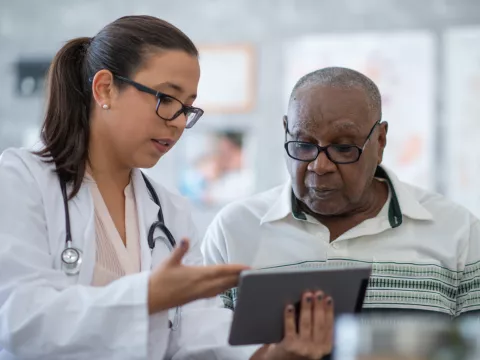 A Physician Goes Over a Patient's Chart with Him on a Tablet