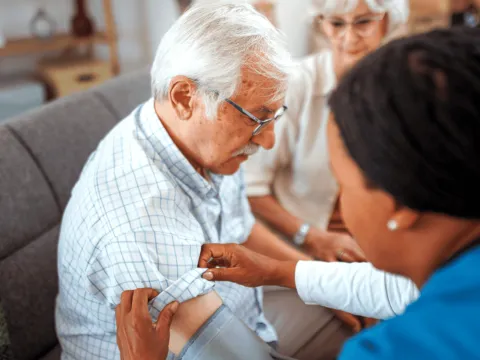 A Senior Man Has His Blood Pressure Taken by a Medical Professional