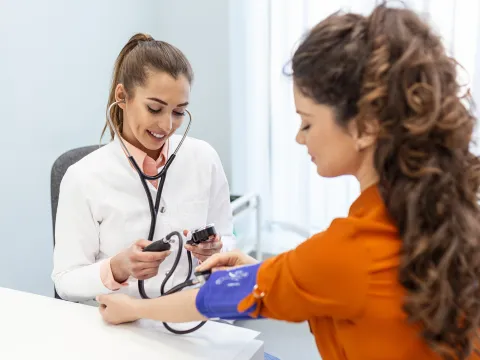 A Provider Takes Her Patient's Blood Pressure