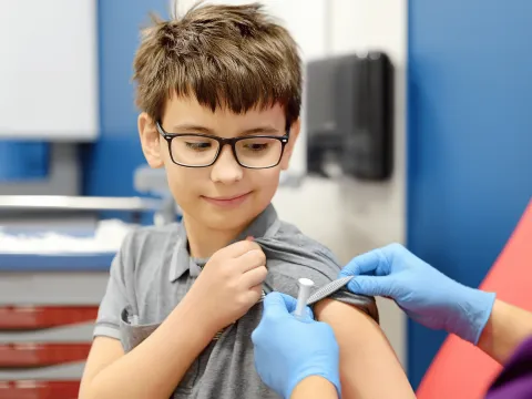 A Boy About to Get a Tetanus Shot in His Bicep 