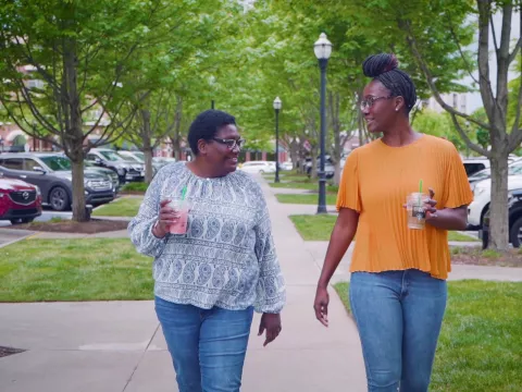 Mother and daughter walking outside