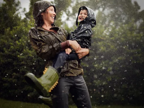 Mom and Child Under a Sprinkler