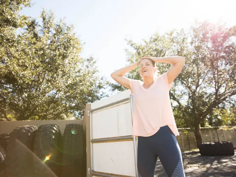 Woman Relaxing with Tires in Background