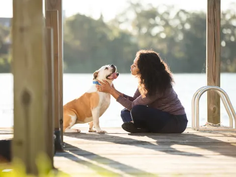 Woman with Her Dog on a Dock