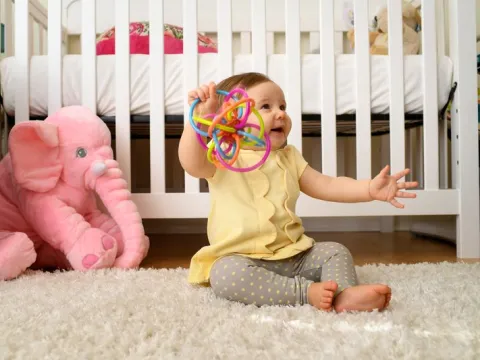 Baby plays with her toy at home