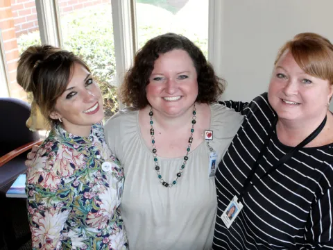Three women hugging each other