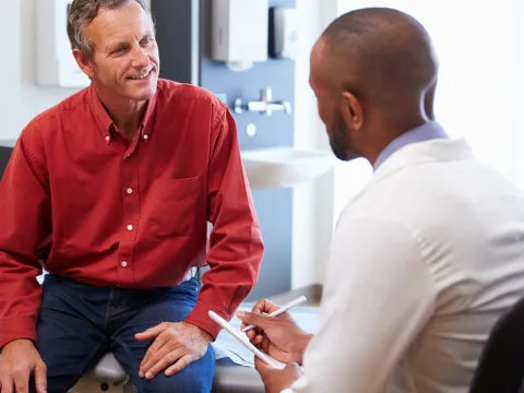 A man discusses his health with his doctor.