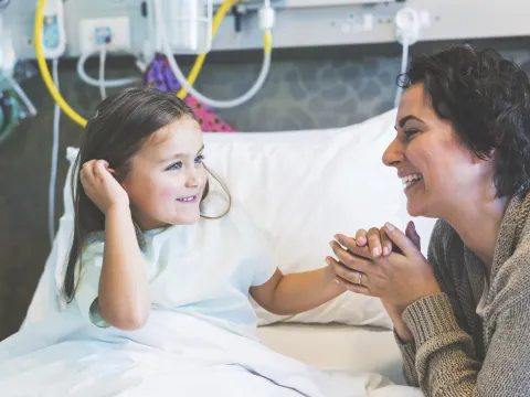 Mom With Young Girl in Hospital Bed