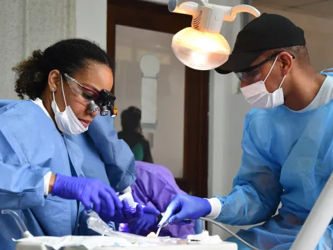 Two people provide dental care to a Guatemalan patient.