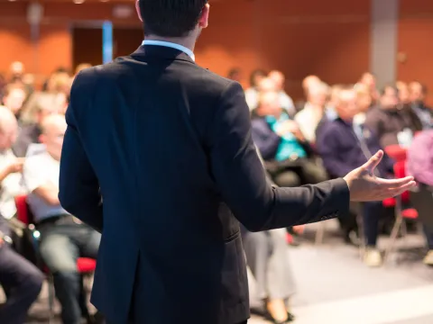 Man giving a lecture to a rapt audience.